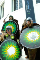 Three Vikings with BP logos on their shields growling in the British Museum